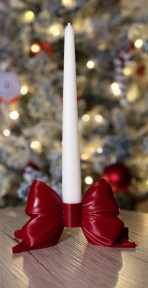 3D printed red bow candle holder with white taper candle festive setting