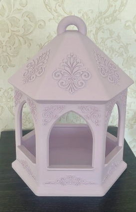 Elegant hexagonal bird feeder in teal to pink variegated gradient, hanging outdoors