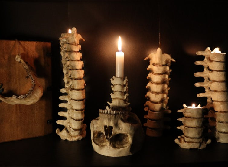 Spine & Skull Candleholder Set - full set displayed with candles lit