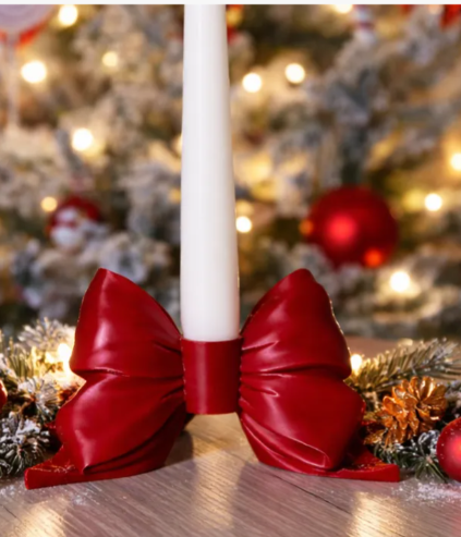 3D printed red bow candle holder with white taper candle Christmas tree background