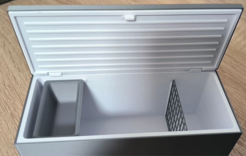 Miniature chest freezer open lid showing interior basket and divider
