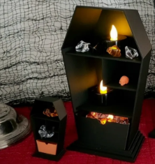 Coffin shelves styled with glowing candles and Halloween decor
