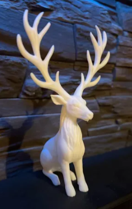 Winter Majesty Reindeer 3D printed white statue side view against stone wall