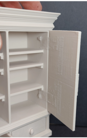 Miniature dollhouse linen cabinet – disassembled showing doors, drawers, and shelving unit