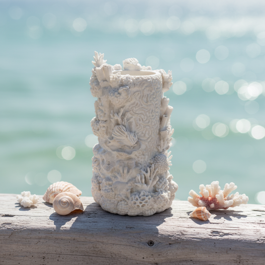 3D printed white coral reef vase on driftwood with ocean background