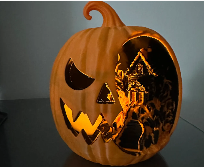 3D printed jack-o-lantern with glowing haunted house scene inside, lit from within