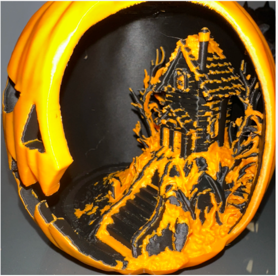 Close-up of the detailed haunted house miniature scene inside the jack-o-lantern